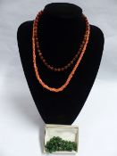 A SINGLE STRAND JADEITE BEAD NECKLACE, THE CLASP STAMPED 750. 48CM LONG TOGETHER WITH A CORAL
