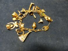 A 9CT GOLD CHARM BRACELET