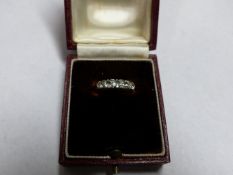 AN 18CT GOLD FIVE STONE DIAMOND RING