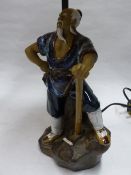 A CHINESE STYLIZED FIGURE MOUNTED AS A LAMP