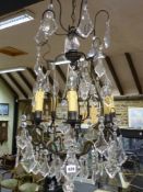 A CAGE CHANDELIER WITH OAK LEAF GLASS DROPS