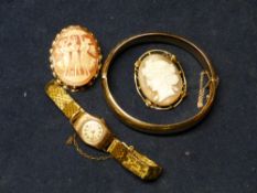 A 9CT GOLD HINGED BANGLE, TWO CAMEO BROOCHES AND A GOLD CASED WATCH