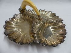 A SILVER PLATED SCALLOP SHAPED HORS D'OEVURES DISH WITH BOARS TUSK HANDLE