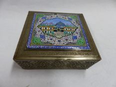 A CONTINENTAL SQUARE SHAPED SILVER COLOURED BOX DECORATED ENAMELLED MOSQUE SCENE WITH MOUNTAINS