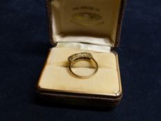 A GOLD & DIAMOND SET FIVE STONE RING