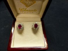 A PAIR OF DIAMOND AND RUBY CLUSTER EARCLIPS