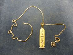 A PRECIOUS YELLOW METAL ( INDISTINCTLY MARKED) EGYPTIAN STYLE PENDANT AND CHAIN