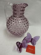 A PAIR OF BACCARAT AMETHYST GLASS BUTTERFLIES AND A MURANO STYLE EWER