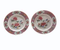 A PAIR OF 18TH CENTURY CHINESE PLATES, THE CENTRES PAINTED PREDOMINANTLY IN FAMILLE ROSE WITH FLORAL