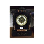 FRENCH BLACK SLATE AND MARBLE INLAID 8-DAY MANTEL CLOCK OF ARCHITECTURAL FORM, THE UNSIGNED DIAL