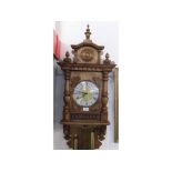 20TH CENTURY THREE WEIGHT WALL CLOCK IN THE CONTINENTAL STYLE, THE ARCHITECTURAL CASE WITH APPLIED