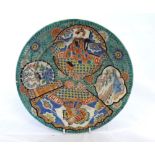 A CHINESE CIRCULAR PLATE, PAINTED WITH PANELS OF INTERIOR AND LANDSCAPE SCENES ON A PREDOMINANTLY