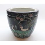 A CHINESE FAMILLE NOIR JARDINITRE OF CIRCULAR FORM DECORATED WITH BIRDS AMONGST FOLIAGE, 9" HIGH