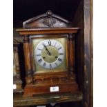 20TH CENTURY MANTEL CLOCK WITH STAINED WOODEN ARCHITECTURAL CASE, THE METAL DIAL WITH ROMAN NUMERALS