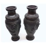 A PAIR OF CHINESE BRONZE BALUSTER VASES, EMBOSSED WITH COILED DRAGONS, 12" HIGH