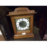 LATE 19TH CENTURY OAK CASED 8-DAY MANTEL CLOCK OF ARCHITECTURAL FORM, THE BRASS FACE WITH LATER