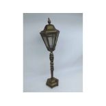 A BRASS LANTERN-STYLE ELECTRIC TABLE LAMP, (LACKING FITTINGS), THE GLAZED TOP WITH HINGED LID,