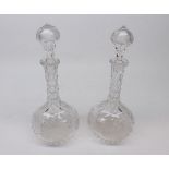 Pair of 20th century clear cut glass decanters, of onion form, decorated with vine leaves, 11" high