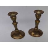 Pair of 19th century brass candlesticks with knopped stems over spreading oval bases, 7" high