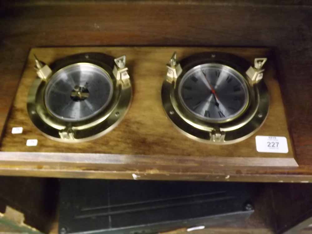 Modern nautical style quartz battery operated spectrum clock and accompanying barometer on wooden