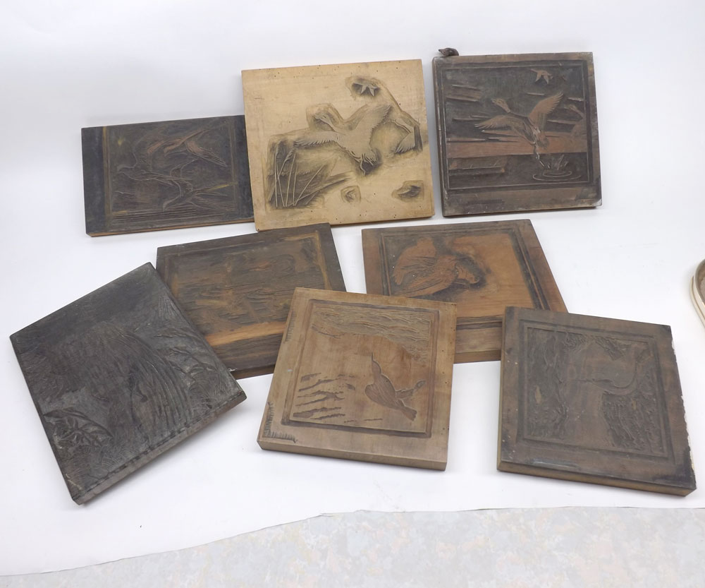 Collection of oriental wooden printing blocks decorated with various designs, birds, landscapes