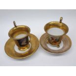 Two 19th century continental gilt decorated cups and saucers, the cups both with panels of classical