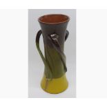 C H Brannam Devon pottery tapering three handled vase, decorated in brown, green and yellow, 10 1/2"