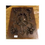 19th century continental wall plaque, decorated with carved central face and floral swags, 19" high