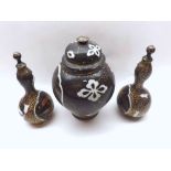 Japanese famille noir composite garniture, comprising a lidded jar and two similar covered double