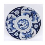 Oriental circular plate, painted in underglaze blue with compartmentalised design of grotesque masks