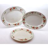 Graduated set of three Poppyland oval meat plates with gilded rims, retailers marks for Jarrold