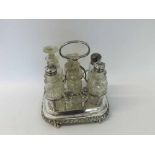 Victorian electroplated cruet stand of shaped rectangular form, with applied thistle and leaf