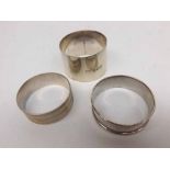 Mixed Lot three assorted Silver Napkin Rings of varying designs, bearing Birmingham and Chester