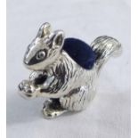 Modern continental novelty pin cushion, modelled in the form of a seated squirrel, with blue