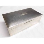 George VI table cigarette box of hinged rectangular form, the cover with engine turned decoration