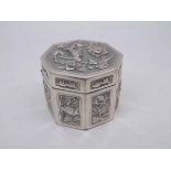 Chinese white metal box of octagonal form fitted with hinged lid, the body decorated with panels