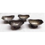 Four Victorian open salts each of half fluted rectangular form with canted corners on pedestal feet,