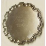 George V presentation inscribed salver with shaped rim and raised on three cast and applied feet and