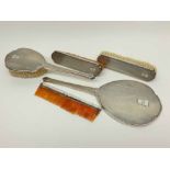 George V silver backed three-piece dressing table set comprising mirror and two brushes, all with