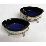 A pair of Edward VII open salts, the pierced oval bodies on cast applied scrolling feet,