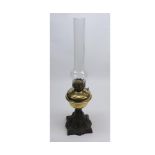 Small oil lamp, clear glass chimney, brass font and pierced cast iron base, 20" high