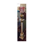 Large oil lamp, frilled cranberry tinted shade, brass font, raised on a large polished marble