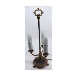 Early 20th century three branch base metal table lamp, raised on paw feet, 20" high