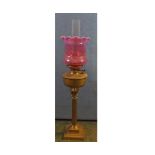 Victorian oil lamp, clear glass chimney, cranberry tinted shade, brass font and Corinthian column