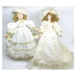 Two large modern porcelain faced dolls, in flowing white dresses