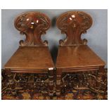 Pair of Victorian mahogany hard seat hall chairs, raised on turned front legs, 18" wide