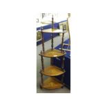 Victorian bow fronted four tier whatnot, each shelf inlaid with a central marquetry panel and raised