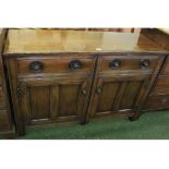 20th century oak two-door two-drawer sideboard of carved detail, 54" wide