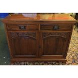 Late Victorian American walnut sideboard with two drawers and two doors, applied with carved detail,