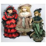 Group of three modern porcelain headed dolls, in various costumes